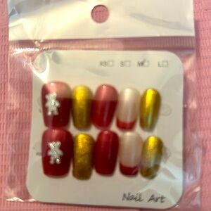 Adorable red and gold nails with teddy bear design